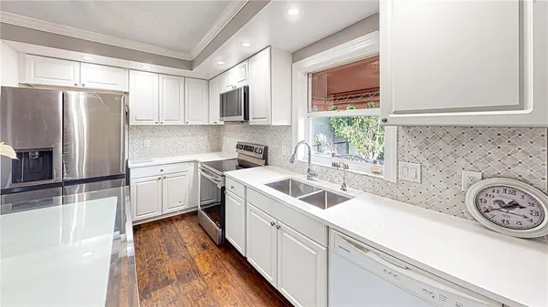 a kitchen with a sink cabinets and stainless steel appliances