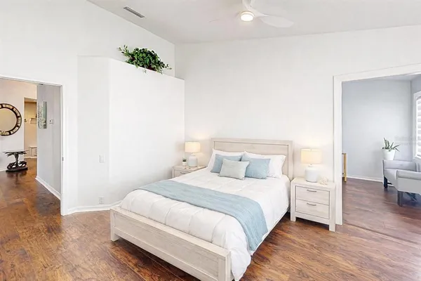 a bedroom with a bed and a potted plant