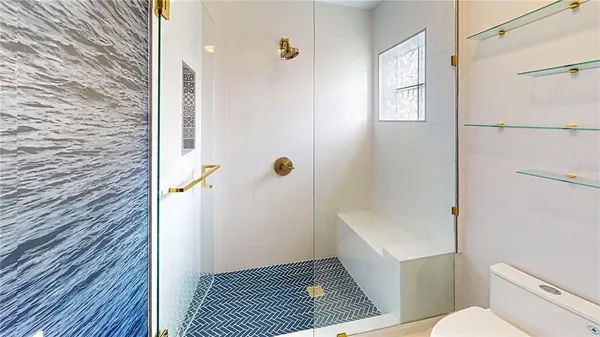 a bathroom with a toilet and a shower
