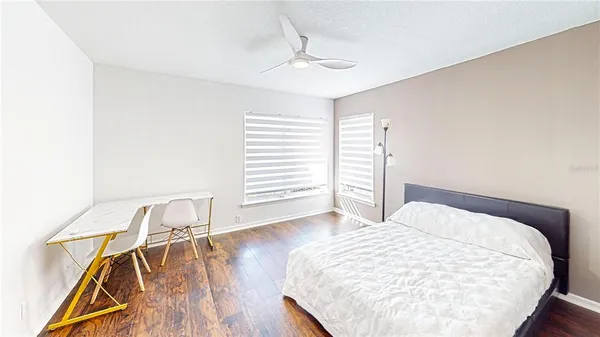 a bedroom with a bed and wooden floor