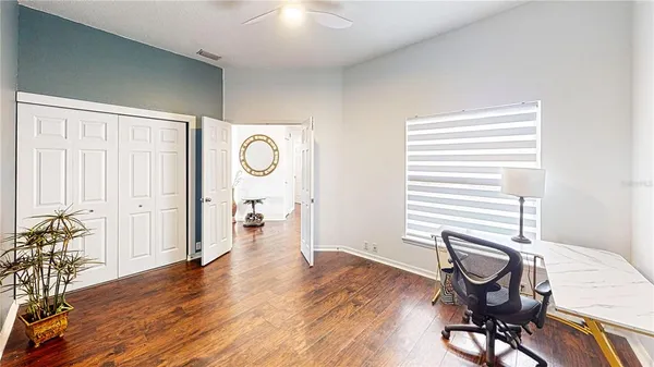 a view of a workspace with furniture and a window