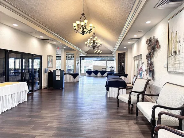 a dining room with furniture a rug and a floor to ceiling window
