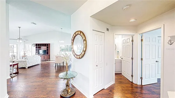 a living room with furniture a table and wooden floor