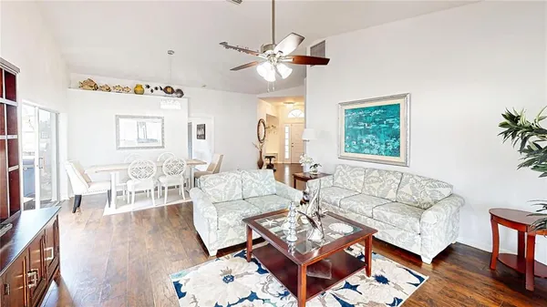 a living room with fireplace furniture and a wooden floor