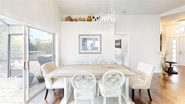 a view of a dining room with furniture wooden floor and a chandelier