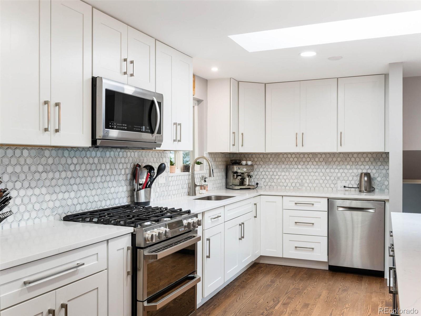 1826 Smith Road Golden, CO 80401 - Photo 11 of 35 a kitchen with cabinets stainless steel appliances a sink and wooden floor