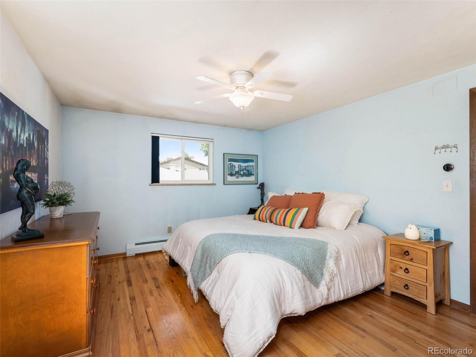 1826 Smith Road Golden, CO 80401 - Photo 17 of 35 a bedroom with a bed and wooden floor
