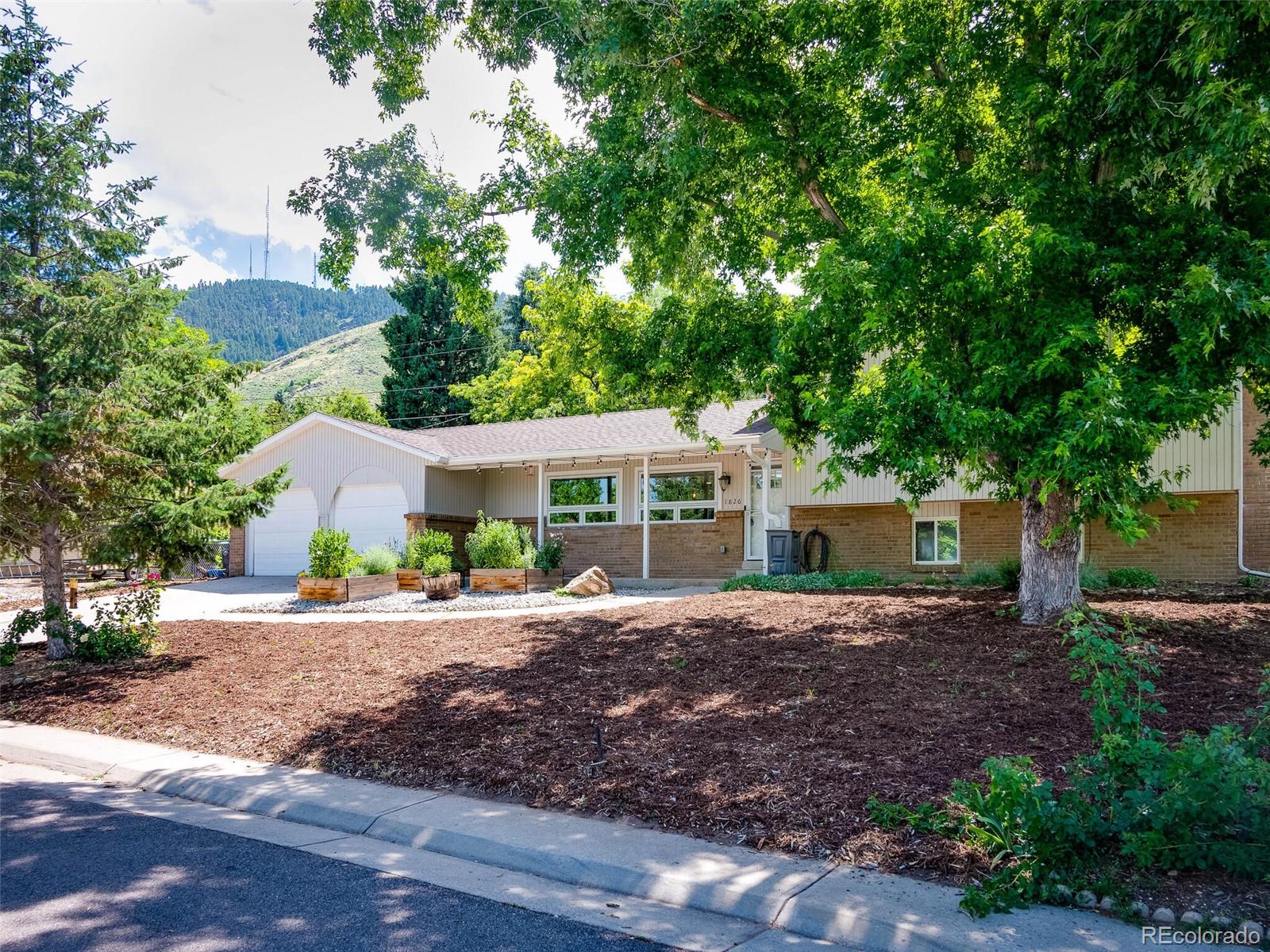 1826 Smith Road Golden, CO 80401 - Photo 2 of 35 a front view of a house with a garden
