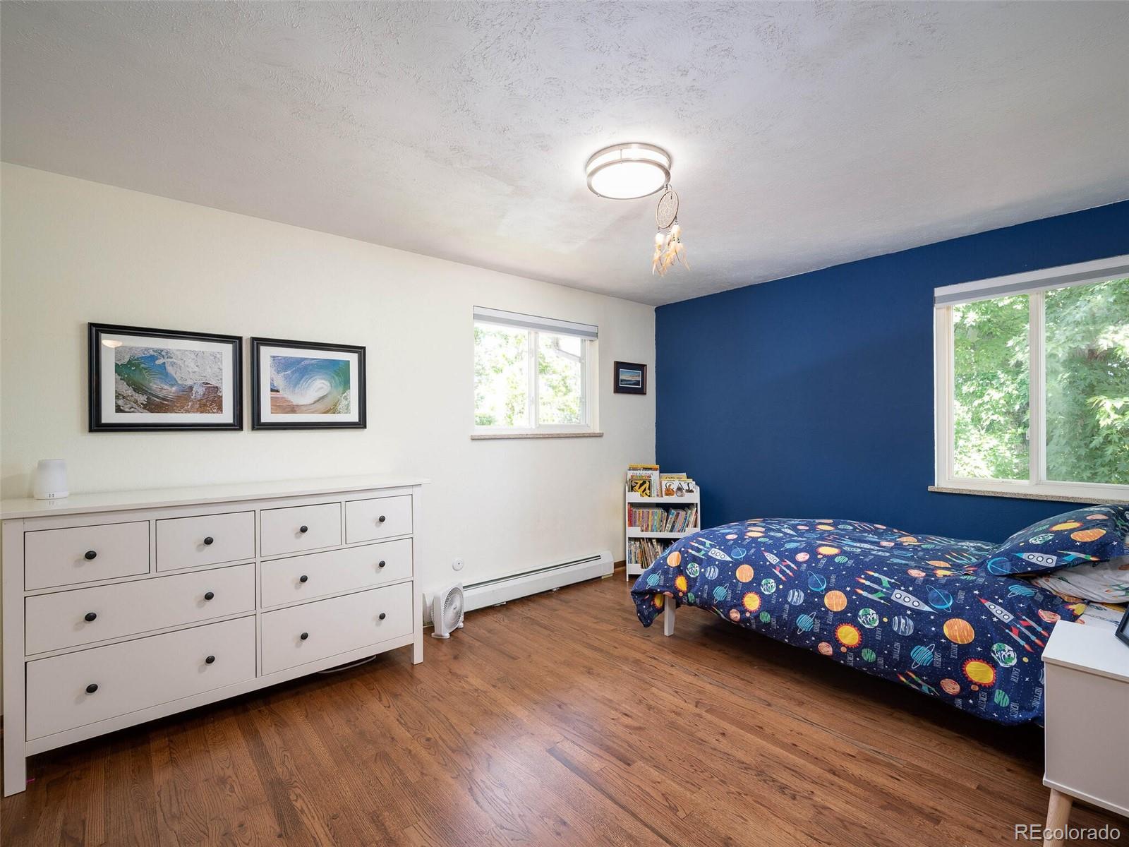 1826 Smith Road Golden, CO 80401 - Photo 21 of 35 a bedroom with a dresser and a window