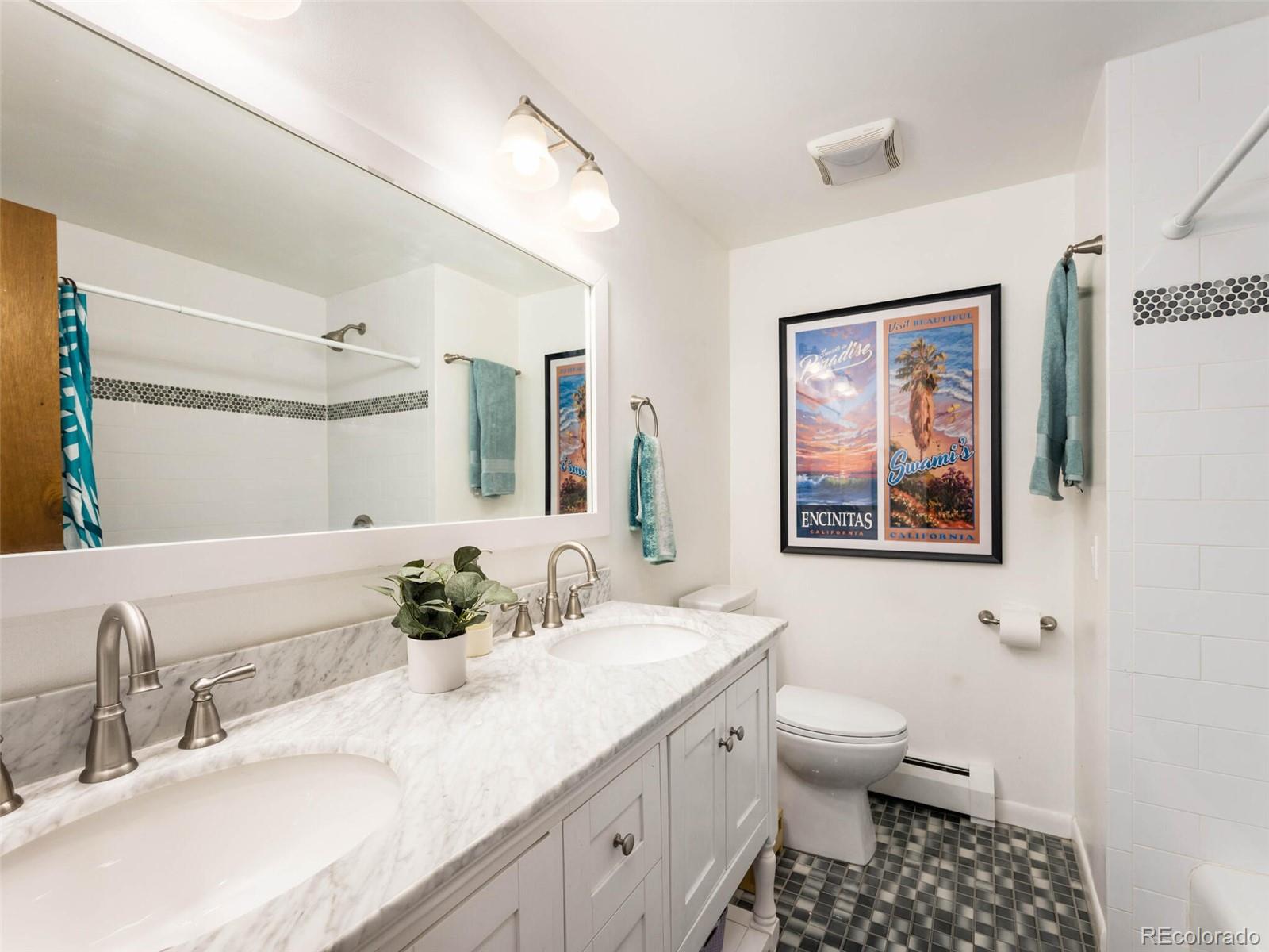 1826 Smith Road Golden, CO 80401 - Photo 24 of 35 a bathroom with a sink a toilet and a mirror