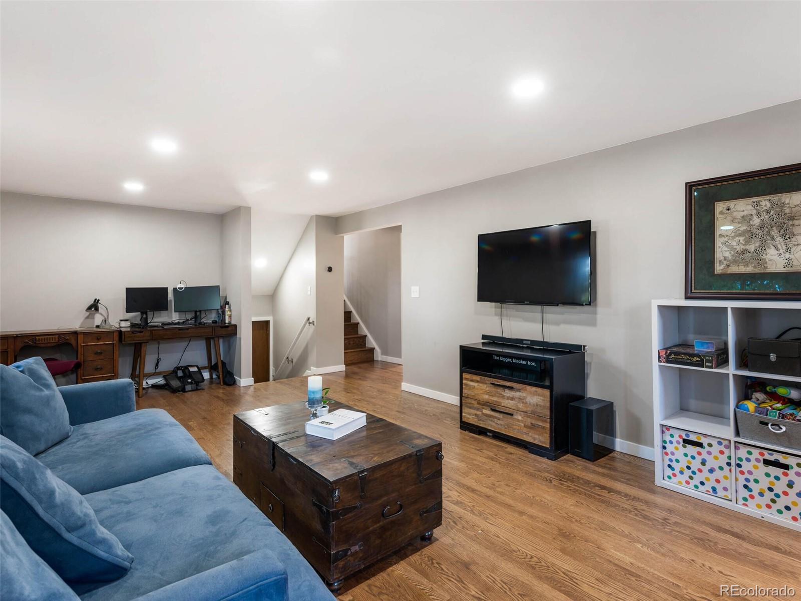 1826 Smith Road Golden, CO 80401 - Photo 27 of 35 a living room with furniture and a flat screen tv