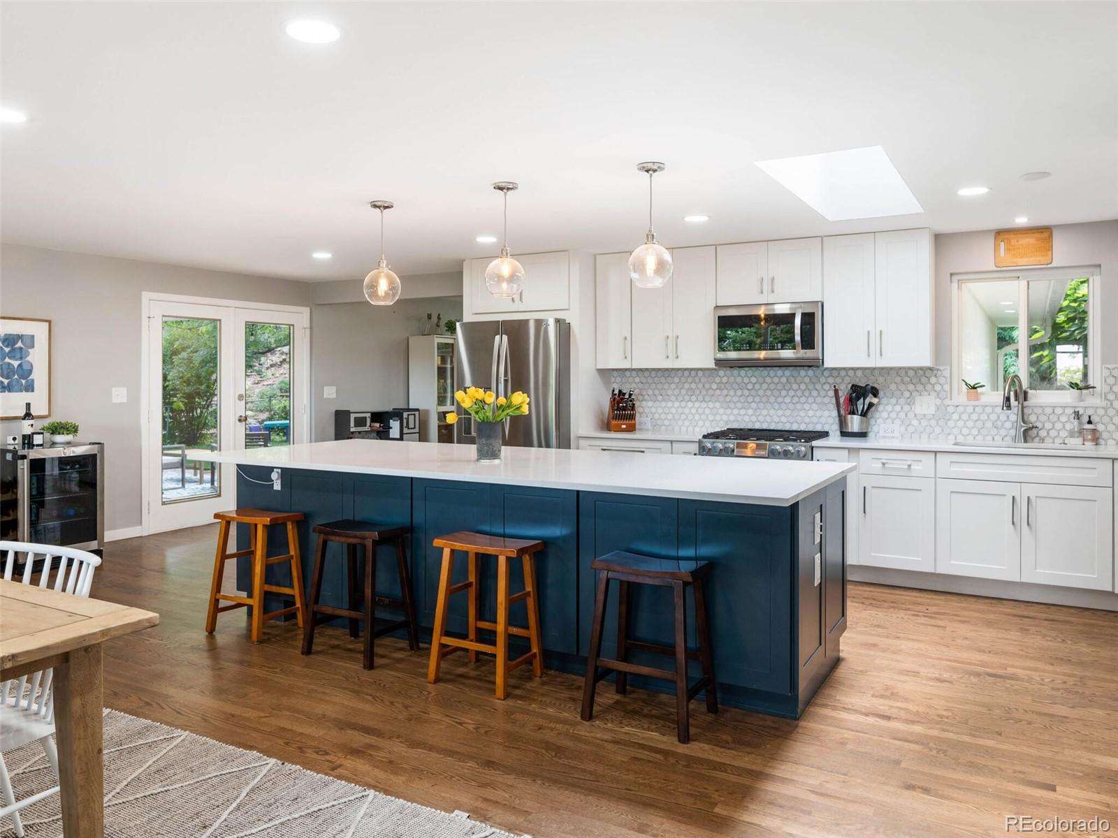 1826 Smith Road Golden, CO 80401 - Photo 5 of 35 a kitchen with kitchen island granite countertop a sink counter top space appliances and cabinets