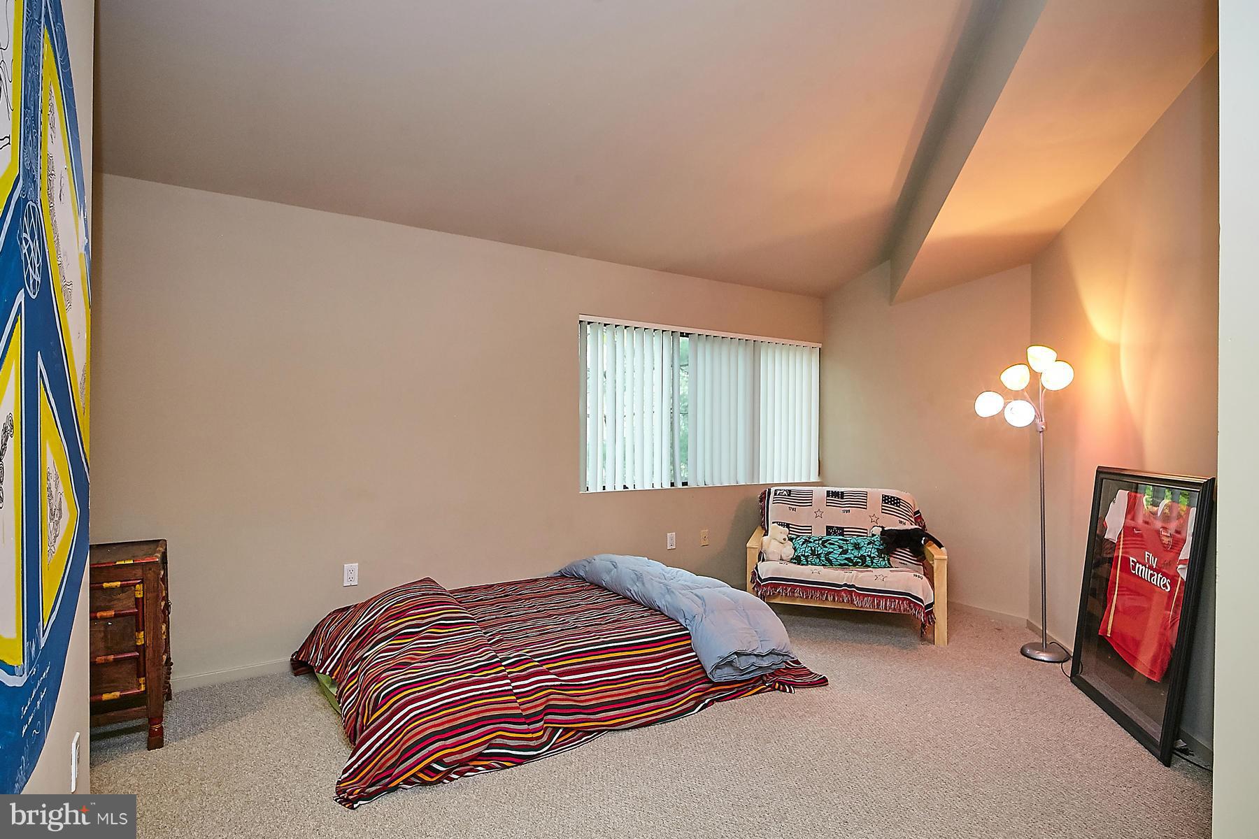 2265 Compass Point Lane Reston, VA 20191 - Photo 20 of 30 a bedroom with a bed and a couch