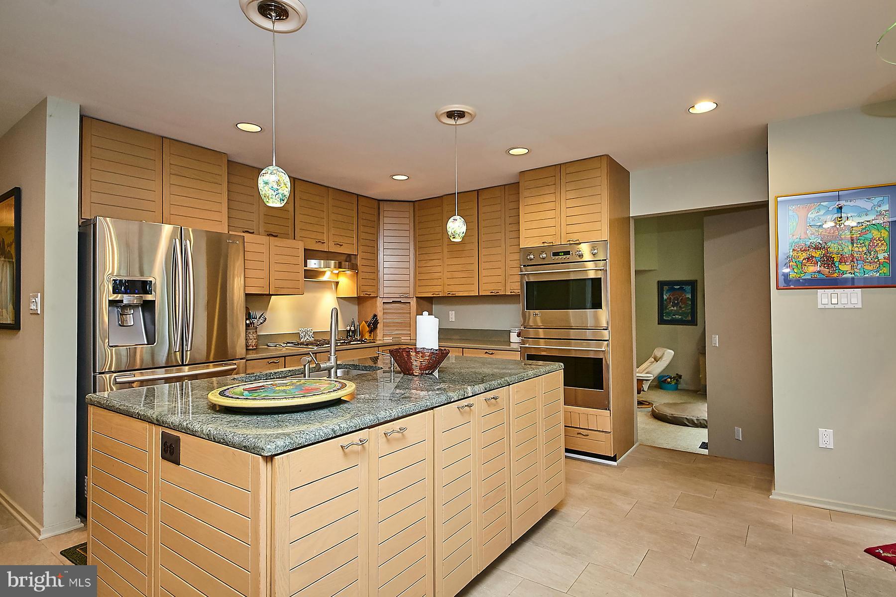 2265 Compass Point Lane Reston, VA 20191 - Photo 10 of 30 a kitchen with stainless steel appliances kitchen island granite countertop a sink refrigerator and cabinets