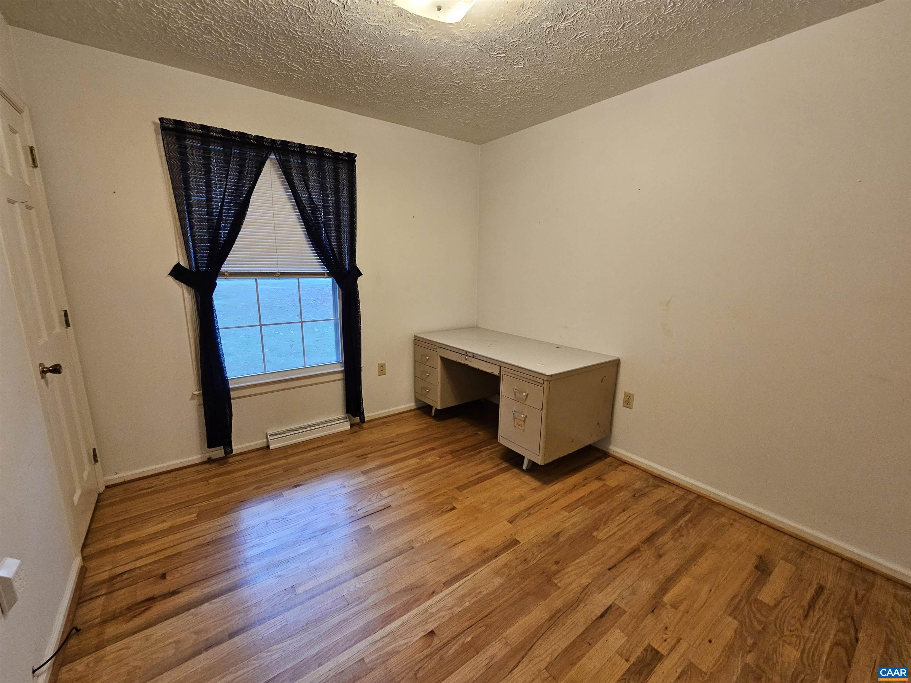 226 Fanny White Road Buckingham, VA 23921 - Photo 16 of 29 an empty room with wooden floor and cabinet