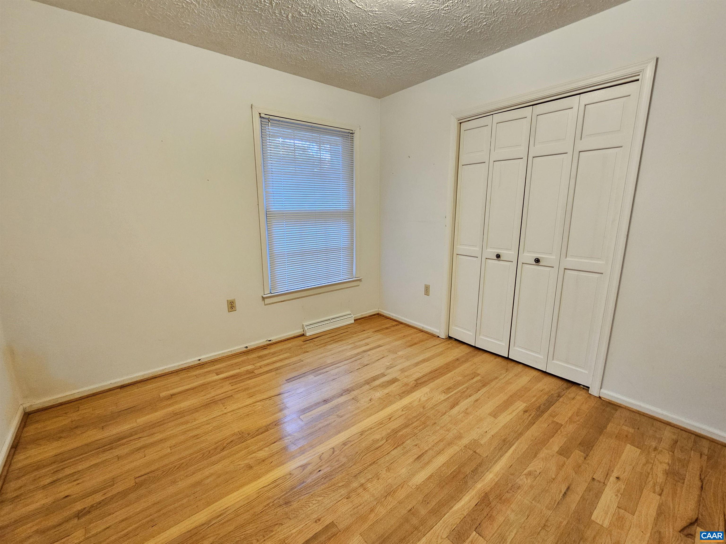 226 Fanny White Road Buckingham, VA 23921 - Photo 18 of 29 a view of empty room with wooden floor and fan