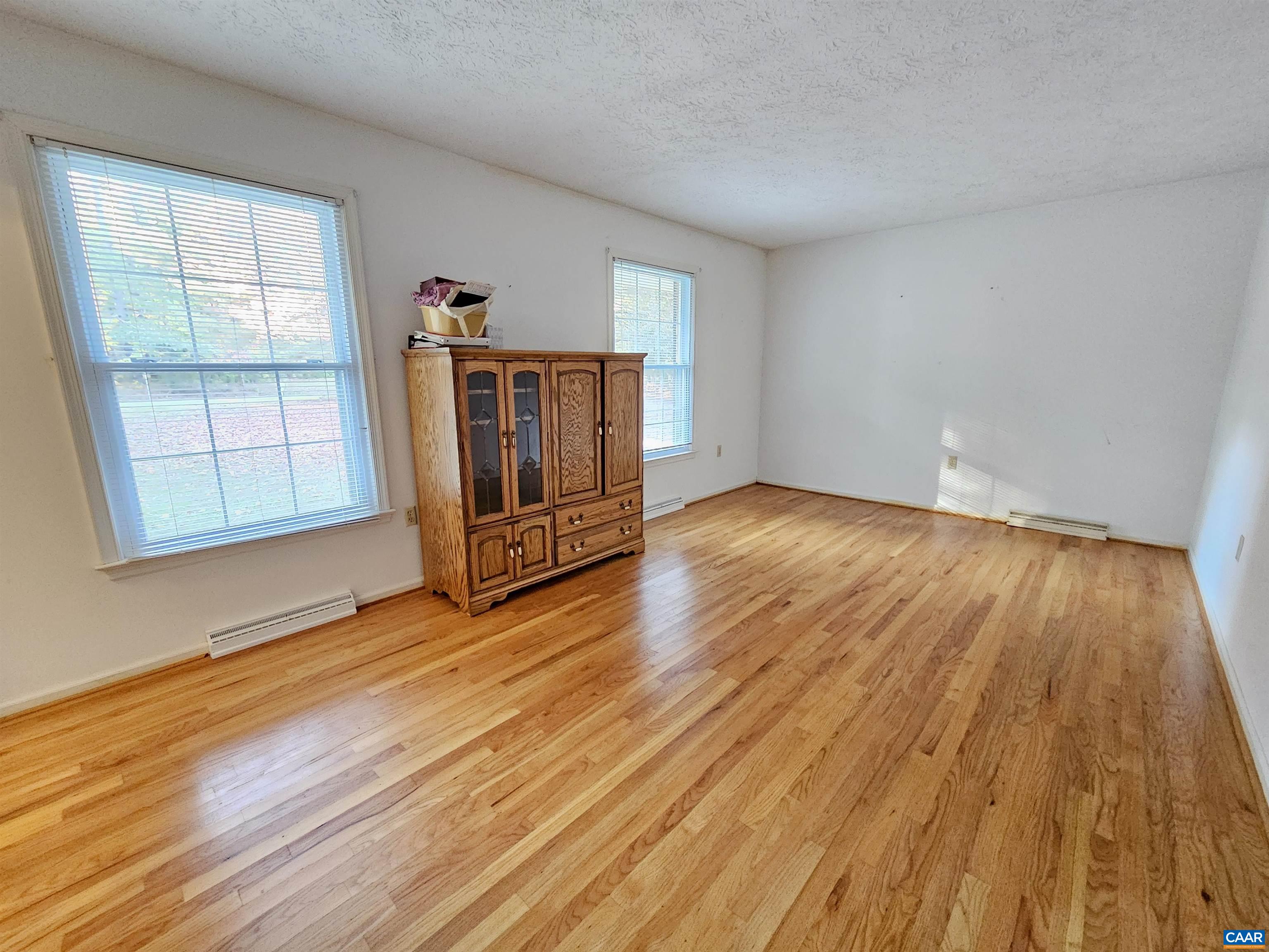 226 Fanny White Road Buckingham, VA 23921 - Photo 5 of 29 an empty room with wooden floor and windows