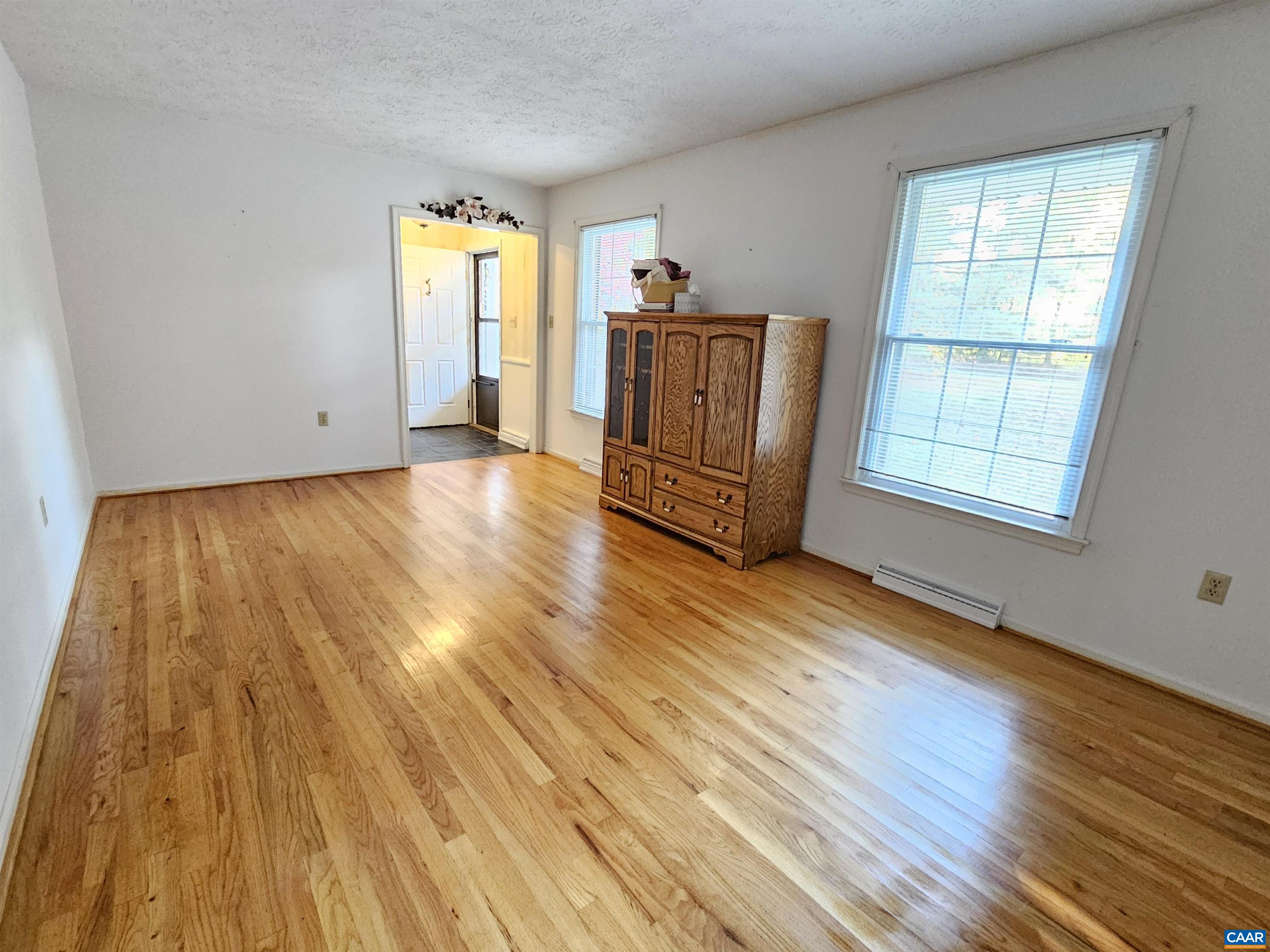 226 Fanny White Road Buckingham, VA 23921 - Photo 6 of 29 a view of an empty room with wooden floor and a window