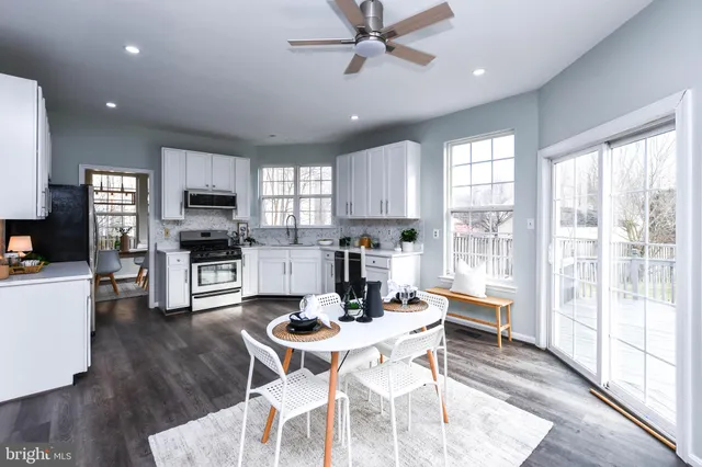 a kitchen with white cabinets and appliances