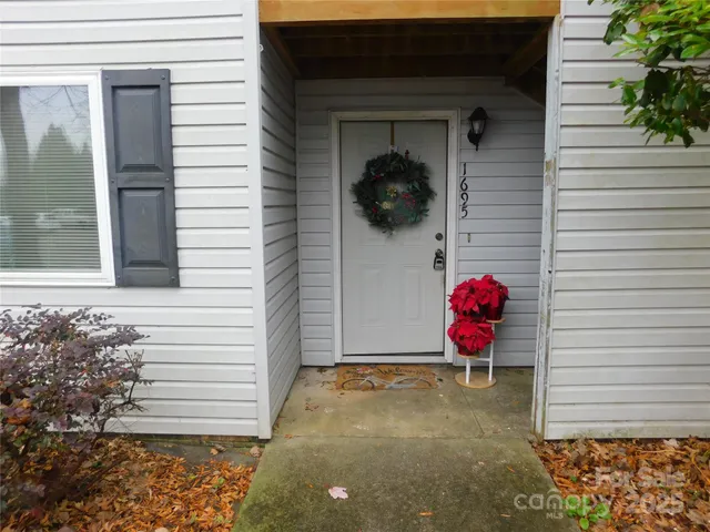 a view of a room with a door and wooden floor