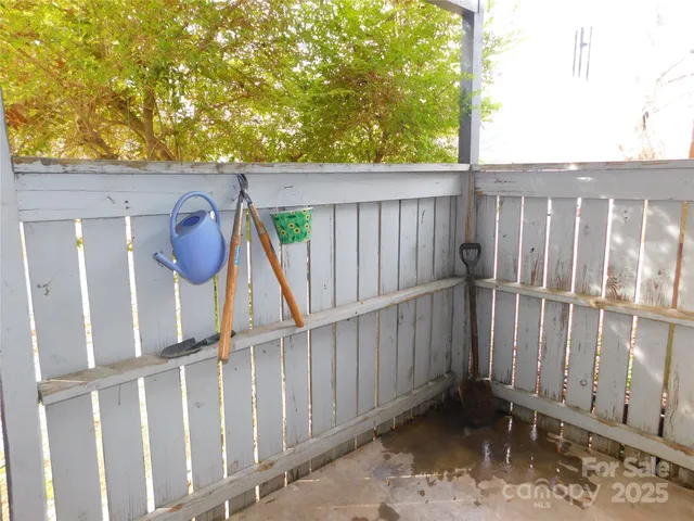 a view of a house with backyard and wooden fence