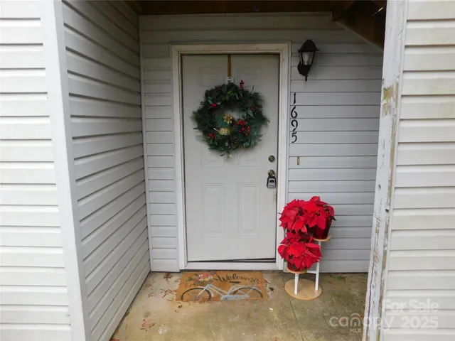 a view of a room with a door and wooden floor