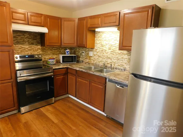 a kitchen with a refrigerator sink and stove
