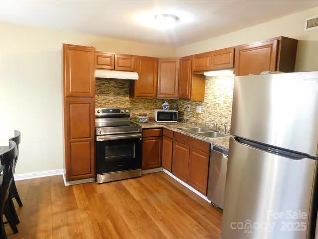 a kitchen with a refrigerator sink and microwave