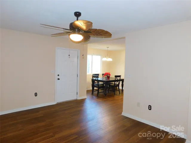 a view of dining room with wooden floor and furniture