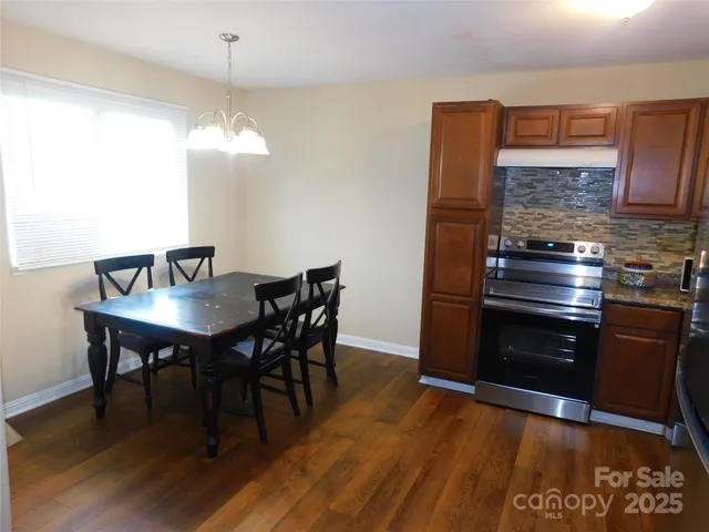 a view of a dining room with furniture wooden floor and chandelier