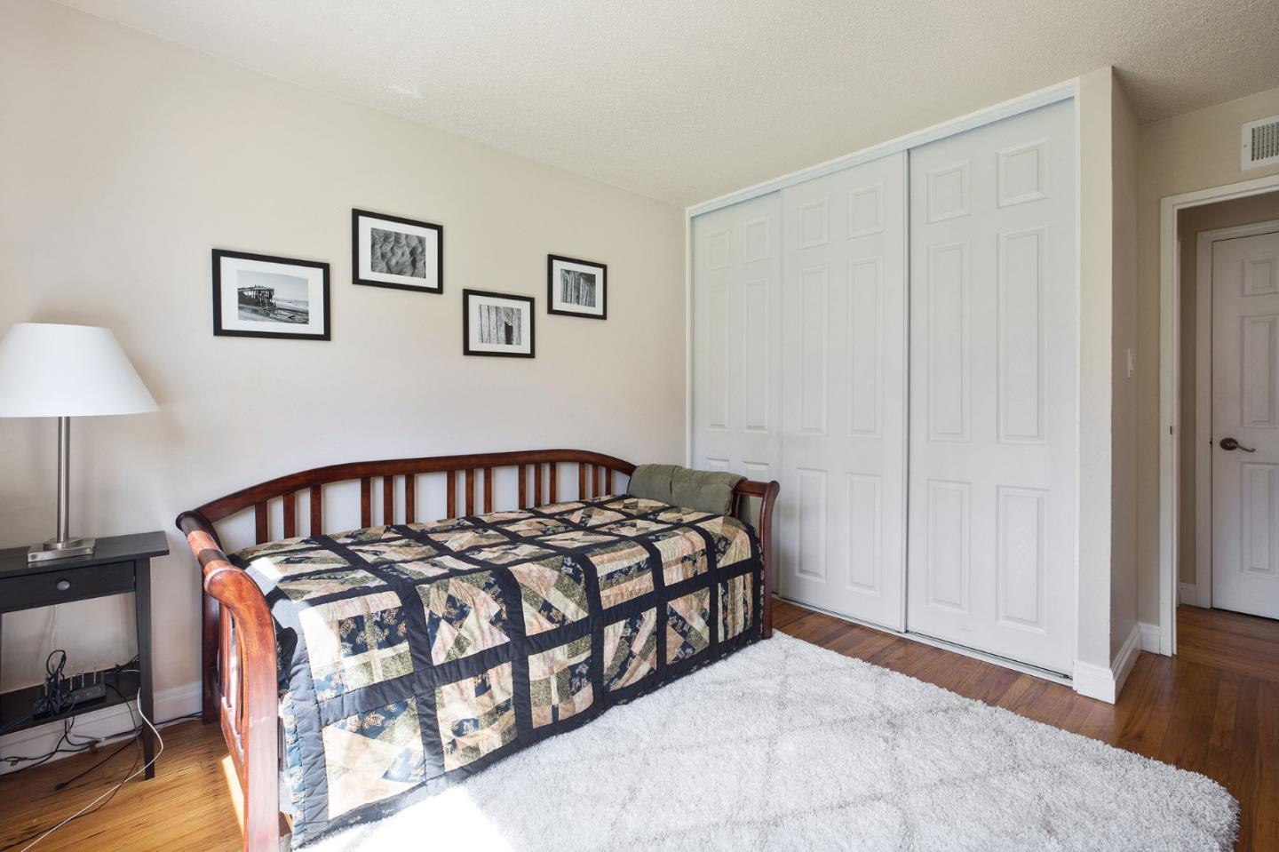 644 Foothill Drive Pacifica, CA 94044 - Photo 12 of 15 a bed room with a bed and a night stand