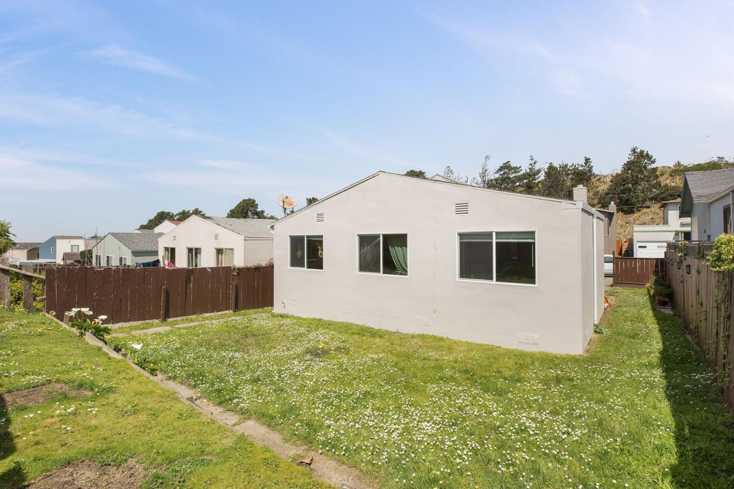644 Foothill Drive Pacifica, CA 94044 - Photo 15 of 15 a view of a white house with a yard and a big yard