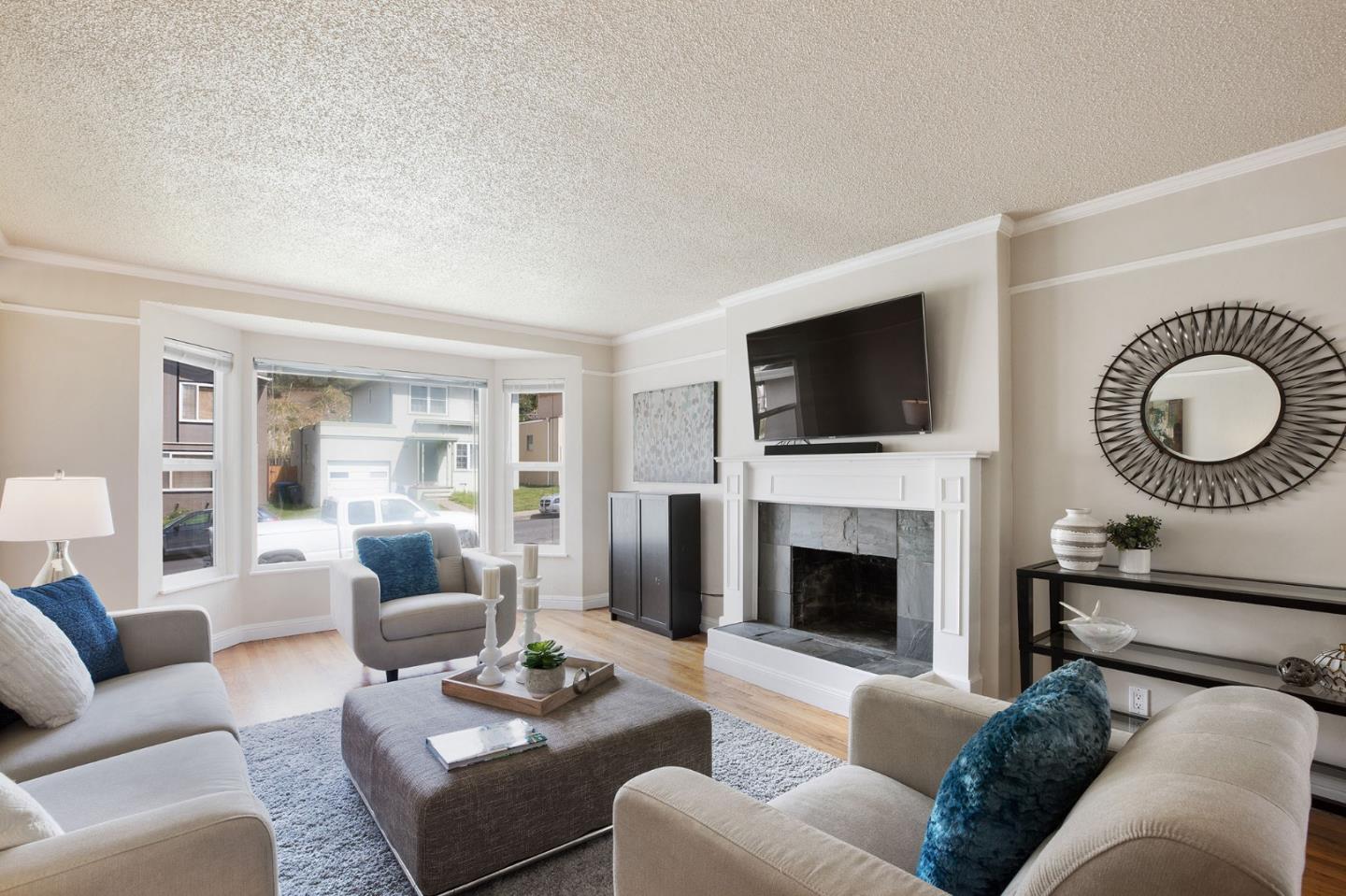 644 Foothill Drive Pacifica, CA 94044 - Photo 2 of 15 a living room with furniture and a fireplace