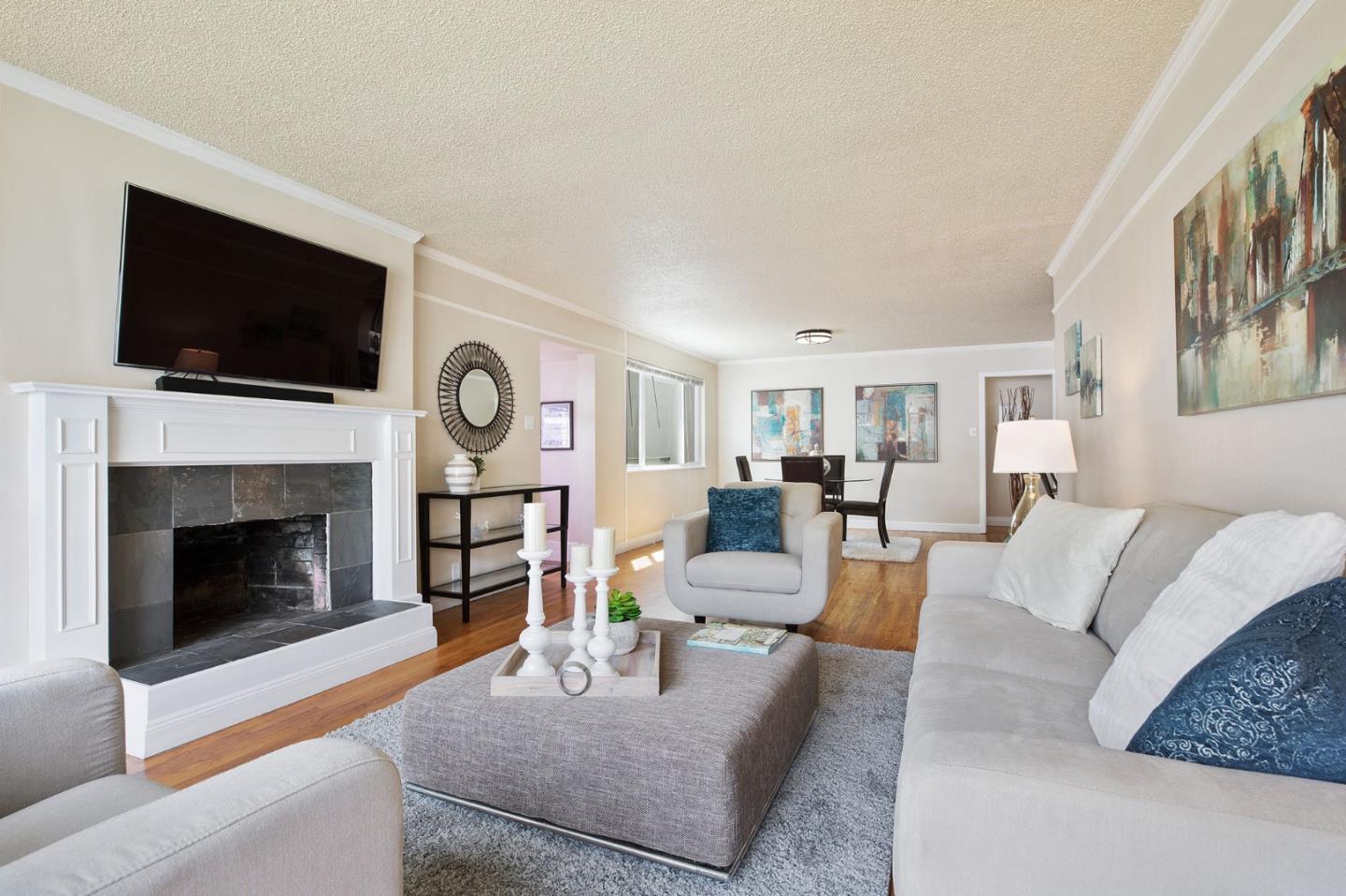 644 Foothill Drive Pacifica, CA 94044 - Photo 3 of 15 a living room with furniture a flat screen tv and a fireplace