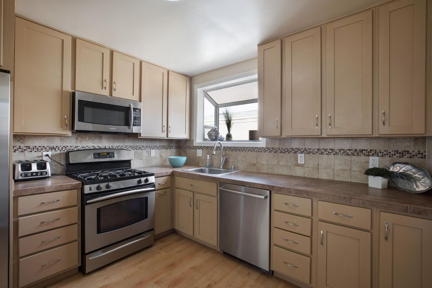 644 Foothill Drive Pacifica, CA 94044 - Photo 6 of 15 a kitchen with sink a microwave and cabinets