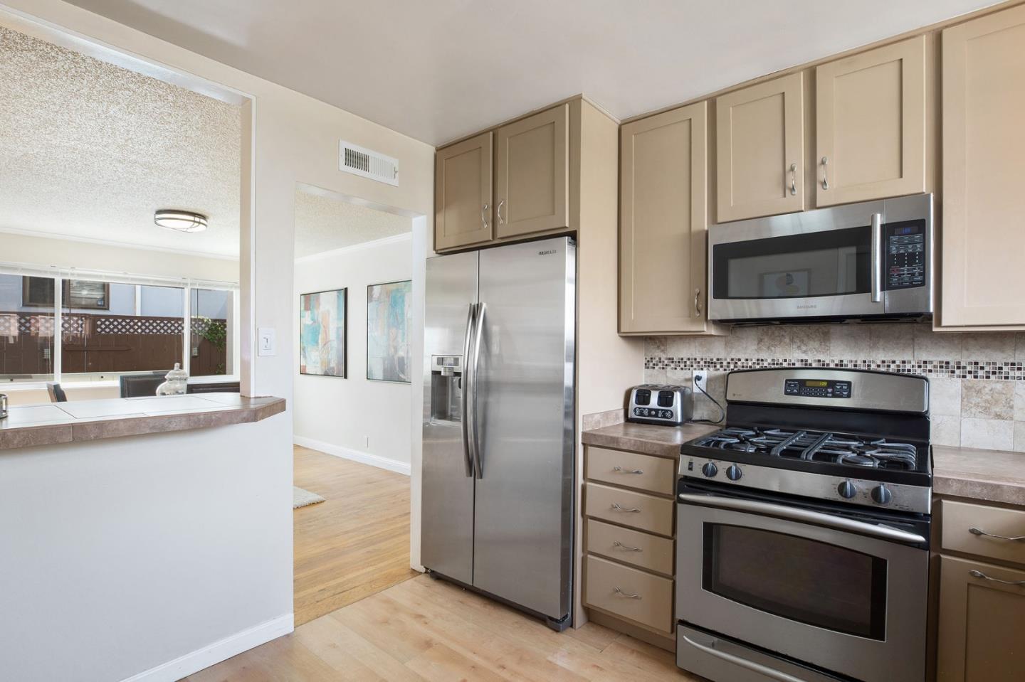 644 Foothill Drive Pacifica, CA 94044 - Photo 7 of 15 a kitchen with stainless steel appliances granite countertop a stove a refrigerator and a microwave
