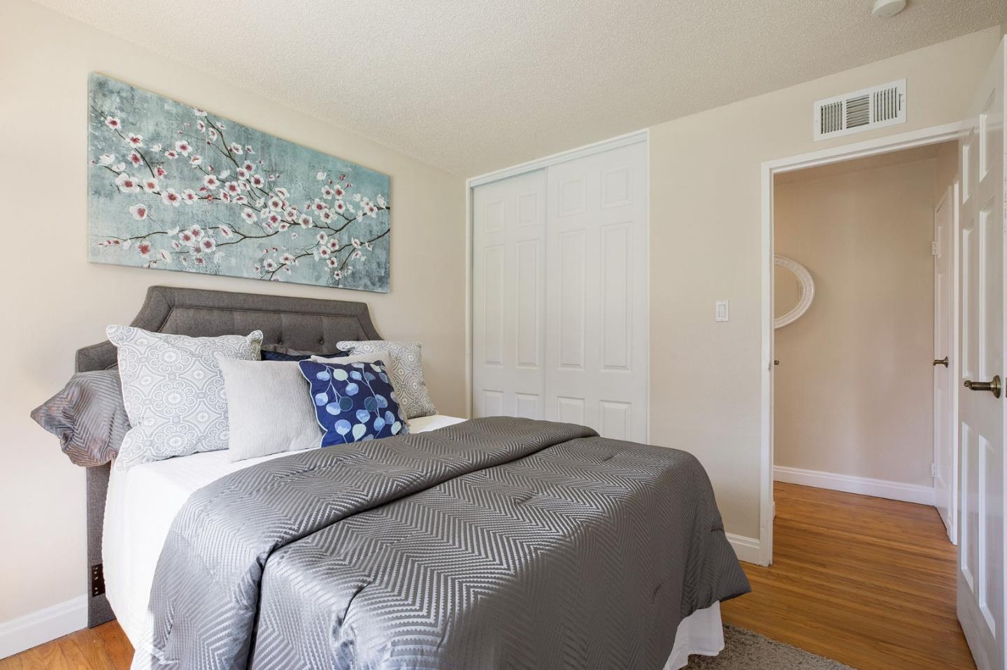 644 Foothill Drive Pacifica, CA 94044 - Photo 9 of 15 a bedroom with bed and wooden floor