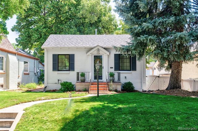 a front view of house with yard and green space
