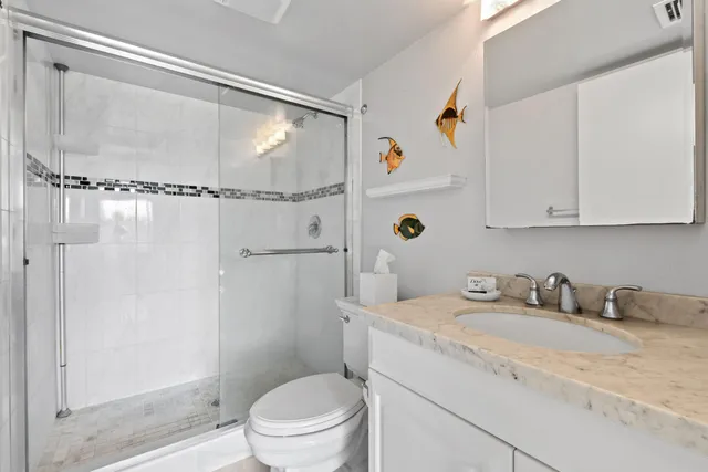 a bathroom with a sink toilet and shower