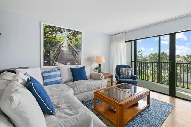 a kitchen with granite countertop a stove a sink and a refrigerator