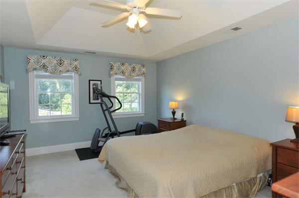10 Oregon Road Ashland, MA 01721 - Photo 16 of 28 a bedroom with a bed windows and a chandelier