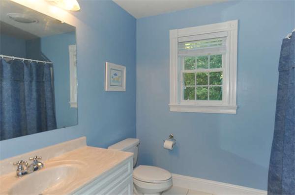 10 Oregon Road Ashland, MA 01721 - Photo 22 of 28 a bathroom with a sink a toilet and a window