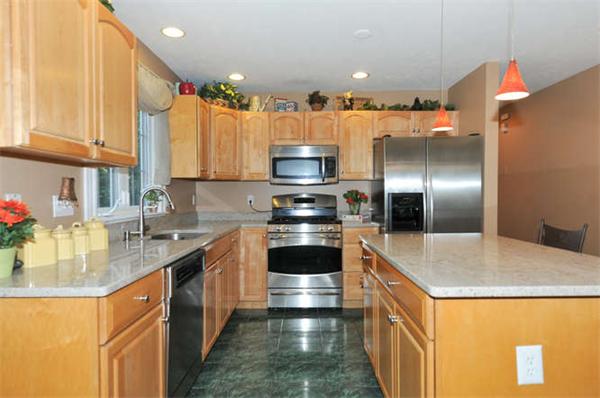 10 Oregon Road Ashland, MA 01721 - Photo 4 of 28 a kitchen with stainless steel appliances granite countertop a sink a stove and a refrigerator