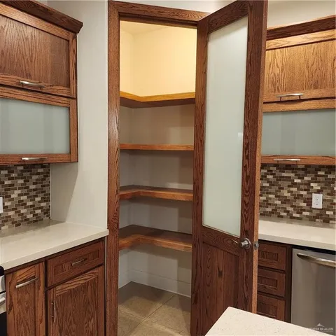 a bathroom with a double vanity sink a large mirror and a shower