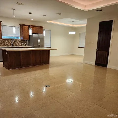 a kitchen with stainless steel appliances kitchen island a refrigerator sink and stove