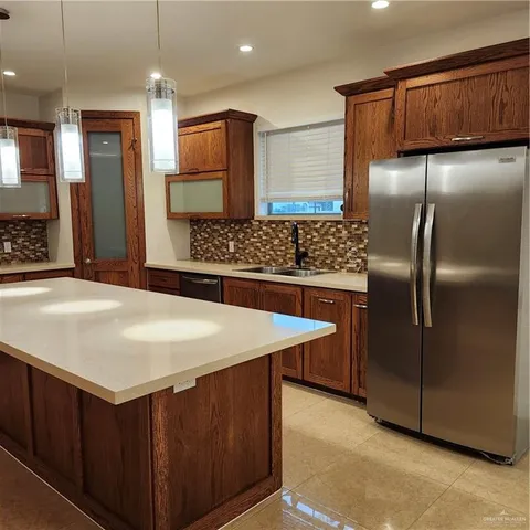 a view of an empty room with a cabinet and a window