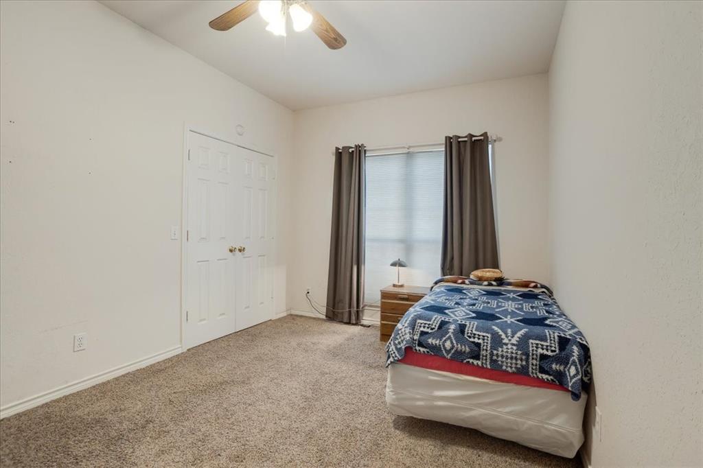 1044 County Road 3230 Windom, TX 75492 - Photo 13 of 40 a bedroom with a bed and a chandelier