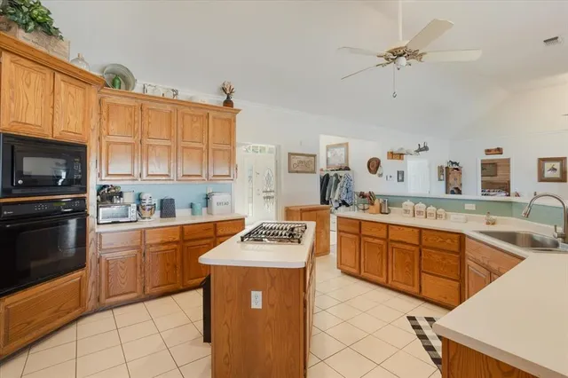 a kitchen with stainless steel appliances granite countertop a stove sink and cabinets