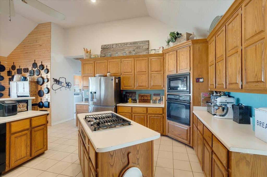 1044 County Road 3230 Windom, TX 75492 - Photo 7 of 40 a kitchen with stainless steel appliances granite countertop a stove a sink and a refrigerator