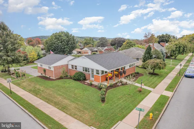 an aerial view of residential houses with yard